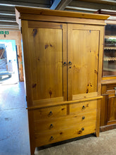 Load image into Gallery viewer, This solid pine wardrobe / larder boasts a beautiful structure and is in excellent condition. While it may have some minor marks from previous use, it still maintains its overall quality. It features a double cupboard with a hanging rail inside, and the base section is equipped with two short drawers and two longer ones for ample storage space. It comes apart for easier moving.  
