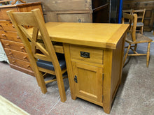 Load image into Gallery viewer, This stunning oak desk and chair set is not only structurally sound and in excellent condition, but also exudes elegance and style. Both pieces were originally purchased from Oak Furniture Land and boast ample storage - the desk features a pull-out desk, a dovetail jointed drawer, and a single cupboard with one shelf. 
