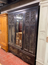 Load image into Gallery viewer, This marvellous antique effect black wooden wardrobe is impressively sturdy and in excellent condition. It features 2 hanging rails and 2 long dovetail jointed drawers for ample storage. It can be disassembled into sections for effortless transportation.
