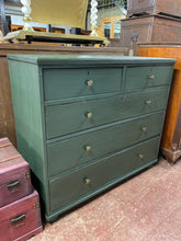 Load image into Gallery viewer, Looking for a beautifully crafted addition to your home? Look no further than this solid wooden chest of drawers, adorned with a striking dark green hue. With 2 short dovetail jointed drawers and 3 long drawers for ample storage space, this piece is not only visually stunning but also functional. Despite some minor damage to the wood, it remains structurally sound and in excellent condition.     
