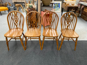 These 4 beautifully crafted wooden wheelback chairs are sturdy and well-maintained. While they may have some slight wear and tear, they are still in excellent condition.  Overall Dimensions  38cm wide x 45cm deep x 89cm high   DELIVERY AVAILABLE