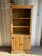 Load image into Gallery viewer, This ideal corona pine bookcase is structurally sound and in overall good condition. It is used and does have some marks but nothing major. The top section has 2 shelves and the bottom section has a double cupboard with 1 shelf in.  Overall Dimensions  80cm wide x 44cm deep x 176.5cm high   
