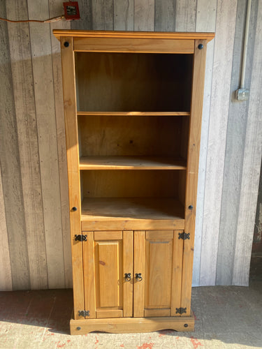 This ideal corona pine bookcase is structurally sound and in overall good condition. It is used and does have some marks but nothing major. The top section has 2 shelves and the bottom section has a double cupboard with 1 shelf in.  Overall Dimensions  80cm wide x 44cm deep x 176.5cm high   