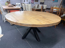 Load image into Gallery viewer, This striking solid mango wood dining table combines natural warmth with industrial style. The round top seats six comfortably, while detachable black metal legs make moving and storage effortless. Built to last, it's a versatile centrepiece for any dining space. RRP £599 on coku home.

Delivery Available

Overall Dimensions

151cm diameter x 78cm high

