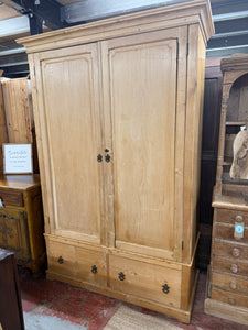 This delightful antique pine wardrobe combines practicality with vintage appeal! In good structural condition, its charming character marks tell stories of the past. Features include a spacious hanging rail and two short drawers with quality dovetail joints. The convenient two-piece design makes transportation a breeze, with the top detaching from the base for easy moving.

Overall Dimensions

142cm wide x 59cm deep x 213cm high

DELIVERY AVAILABLE      

For our other items see our website https://fosseway
