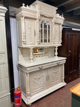 Load image into Gallery viewer, This exquisite French buffet is made of solid wood and is in impeccable condition. While there are a few minor paint marks and small areas of damage, they do not detract from its overall quality. The top is detachable for convenient transportation. The top section boasts 3 cupboards and 2 long shelves, while the base section features 2 drawers over a double cupboard with 1 long shelf inside.  Overall Dimensions  150cm wide x 54cm deep x 247cm high  
