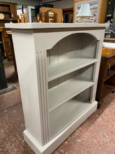 Load image into Gallery viewer, This solid pine bookcase has been painted grey by its previous owners so may need the odd touch up. It is structurally sound and in good condition. It has 2 fixed shelves for storage.

Overall Dimensions

96.5cm wide x 29cm deep x 107cm high 

DELIVERY AVAILABLE    

For our other items see our website https://fossewayfurniture.co.uk

collection from cv36 or bs36

