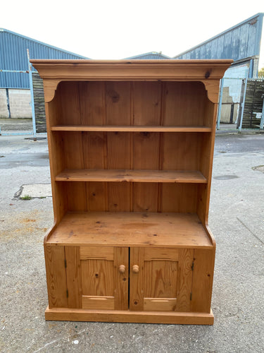 This magnificent antique pine bookcase is in pristine condition and is built to last! It features 2 sturdy shelves on top that provide plenty of space, and a double cupboard with one spacious shelf below. Get ready to be dazzled!  Overall Dimensions  100cm wide x 46cm deep x 141cm high