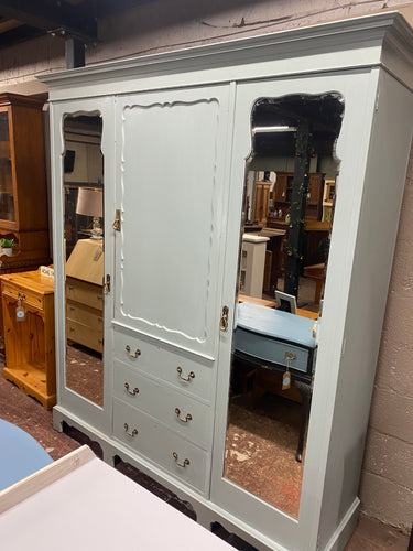 This stunning mahogany compactum has been painted in a duck egg blue shade. It may need some touching up in places but nothing major. This item offers ample storage with 2 single cupboards each with a hanging rail and multiple hooks. The middle section has 2 shelves in the cupboard and 3 long dovetail jointed drawers. This item can come apart into 3 larger sections and 2 smaller sections for easier moving.

Overall Dimensions

approx : 184cm wide x 56cm deep x 211.5cm high 

DELIVERY AVAILABLE    

For our 