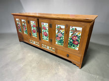 Load image into Gallery viewer, A charming vintage pine sideboard with authentic character. Structurally sound and fully functional, this piece features a double cupboard and two spacious drawers—ideal for storing media equipment, books, or household essentials. The worn finish and minor surface marks reflect its history. The tiles are cracked but this does not affect its use. Perfect as a TV unit or statement storage piece in a living room or hallway.&nbsp;

Delivery Available

Overall Dimensions

150.5cm wide x 49.5cm deep x 66cm high

