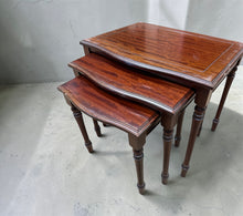 Load image into Gallery viewer, A charming vintage nest of tables by Stag, offering practical storage and display space in a compact footprint. Structurally sound with authentic patina from years of use—minor marks add to its character rather than detract from it. Ideal for positioning beside a sofa, these tables stack neatly when not needed and separate easily for flexible room arrangements.&nbsp;

Delivery Available

Overall Dimensions

large table : 54cm wide x 41cm deep x 46.5cm high&nbsp;

