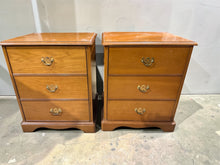 Load image into Gallery viewer, A charming pair of wooden bedside tables, well-built and in good overall condition. Both units show gentle signs of use with minor surface marks that add character rather than detract from their appeal. Each features three practical short drawers, offering ample storage for bedside essentials. Perfect for adding warmth and functionality to any bedroom.

Delivery Available

Overall Dimensions

53cm wide x 43.5cm deep x 65cm high

