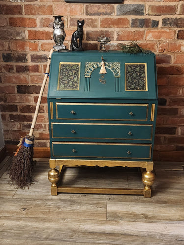 This gorgeous bureau, from around the 1940’s made from solid oak has been redesigned and refinished to create an absolutely stunning, unique piece of furniture.   This piece has been finished in Frenchic Victory Lane green and Plum Pudding paint. Trimmed with gorgeous gold, decoupaged with a forest bee design and golden bee handles.   Finally, the piece has been lacquered and waxed in high quality Frenchic for durability.  Overall Dimensions  Approx: Height 41cm, Width 29cm, Depth  