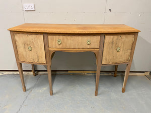 This stunning gorgeous completely stripped back mahogany serpentine dresser is structurally sound and in good condition. It is used and does have the odd mark but nothing too major. It has ample storage with 2 cupboards and 1 long dovetail jointed drawer. The original handles have been kept but have been blasted gold.  Please note this item is bare wood so hasn't had any wax etc for protection. We recommend 'Clear Wax' by Frenchic.  Overall Dimensions  152cm wide x 58.5cm deep x 91.5cm high 