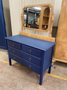 This gorgeous solid pine dressing table has been painted in 'Hornblower' by Frenchic and the mirror has been left natural. This item has been finished off with bronze effect hoop handles. It has ample storage with 2 short dovetail jointed drawers over 2 long. The mirror does come off for easier moving.   Overall Dimensions  106cm wide x 47cm deep x 146cm high 